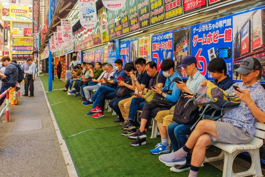 people in line looking at smartphones