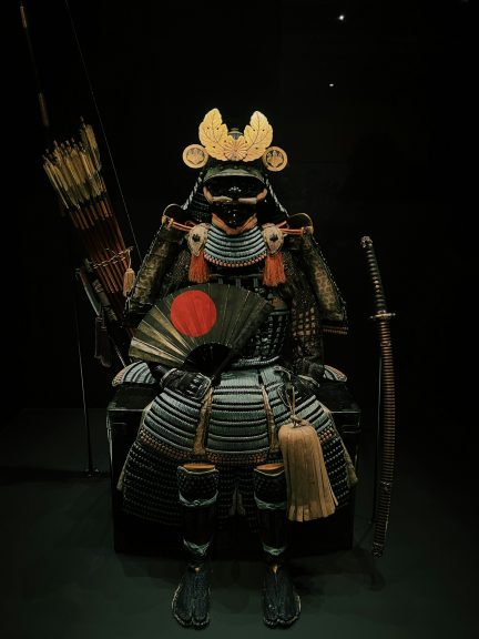 A full set of Japanese samurai armor complete with a bow, arrows, and sword.